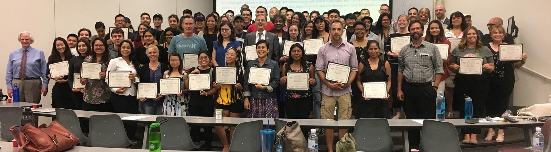 Dozens of certificate recipients pose for photo