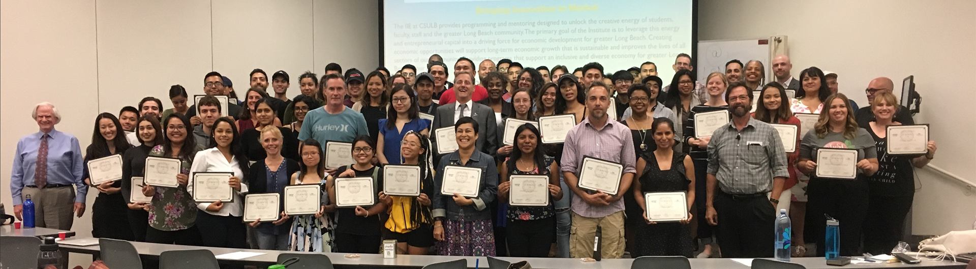 Dozens of certificate recipients pose for photo