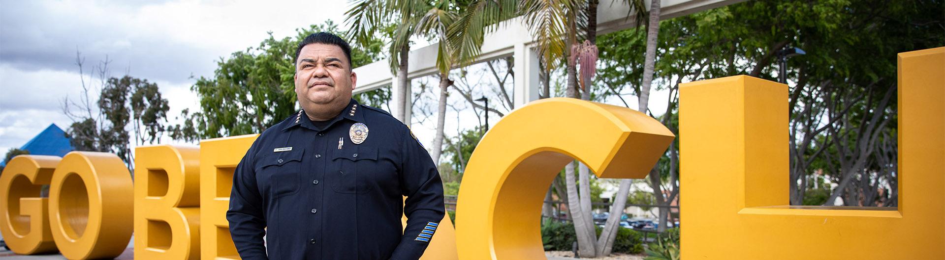 Police chief Fernando Solarzano stands in front of Go Beach letters
