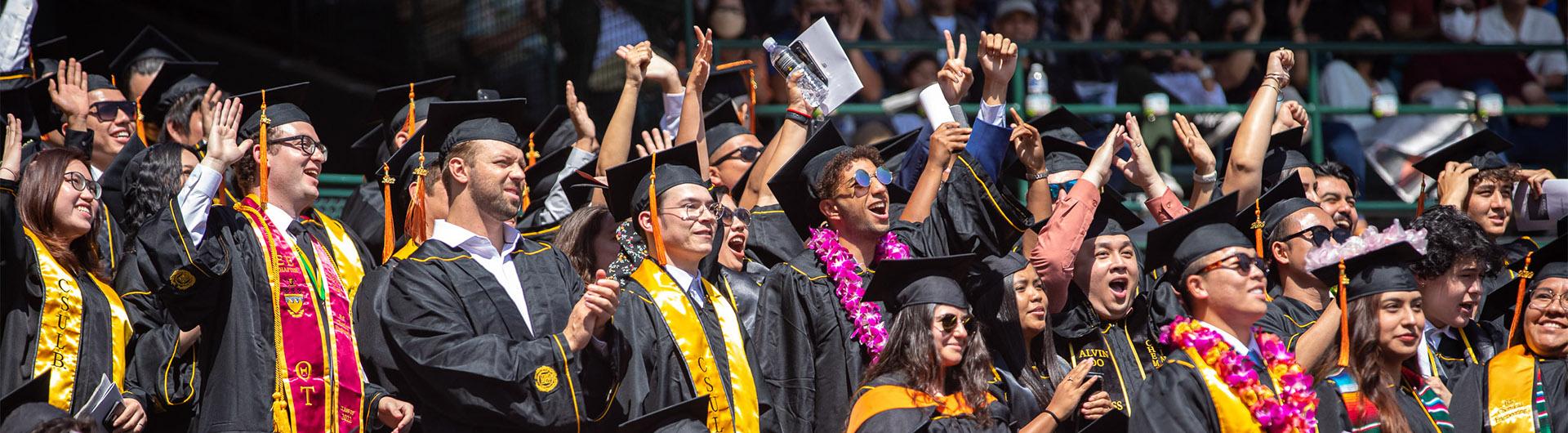 Graduate standing in crowd at commencement