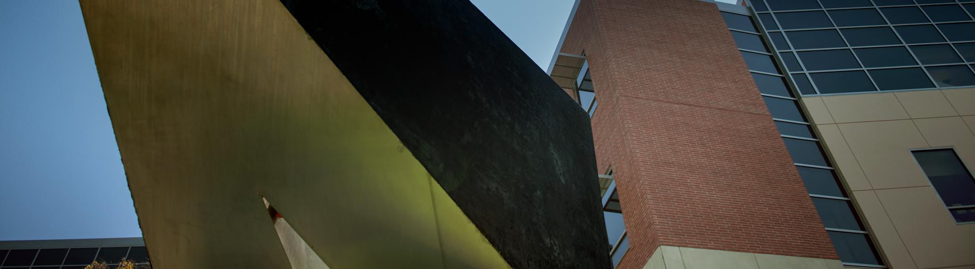 The concrete and stainless steel sculpture Hardfact by artist Kosso Eloul stands watch behind the Molecular and Life Sciences Center on the east side of campus.