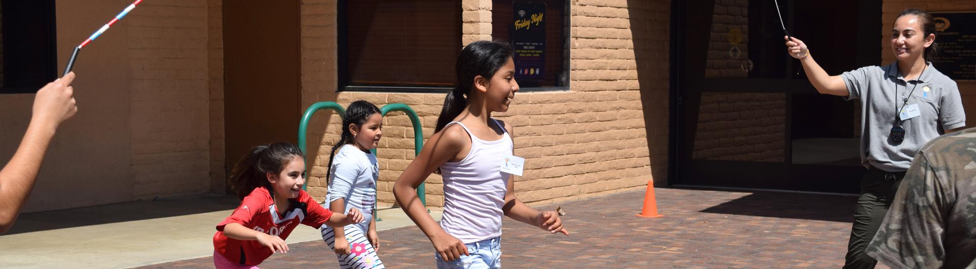 LBC staff jumping rope with young children