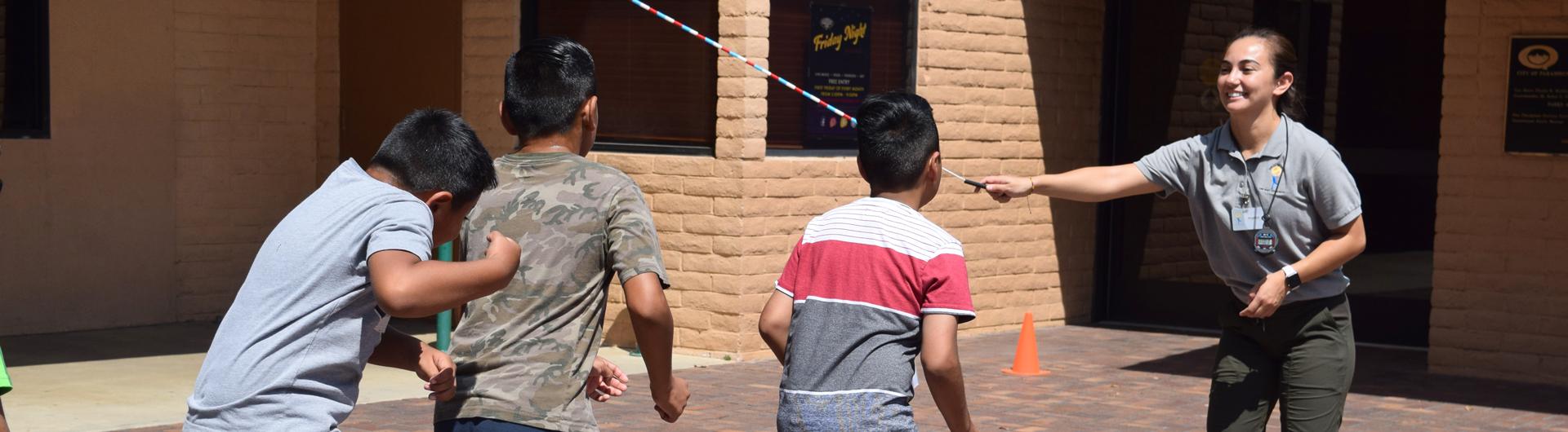 LBC staff jumping rope with young children