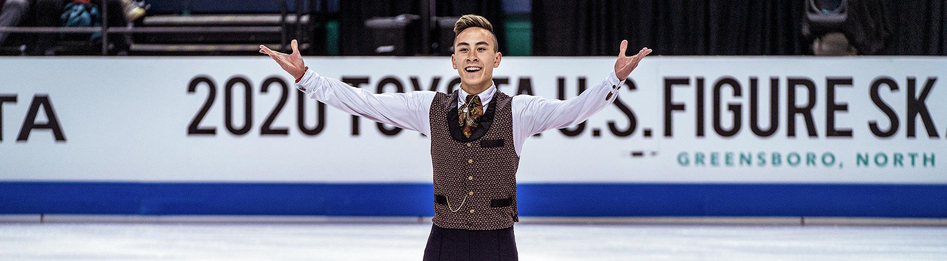Skater Dinh Tran raising his arms after performance