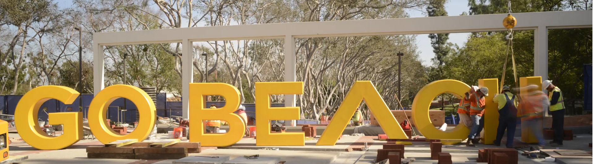 Construction of Go Beach lettering on Campus