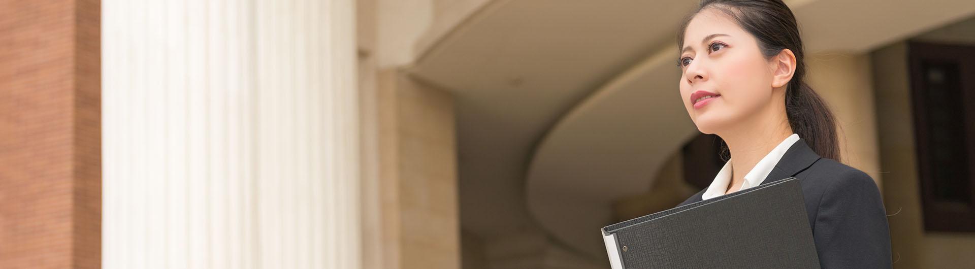 Female government worker standing outside courthouse