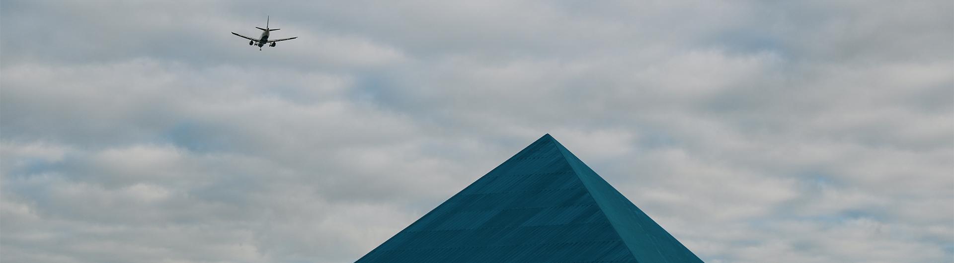 Pyramid and an Airplane in the Clouds