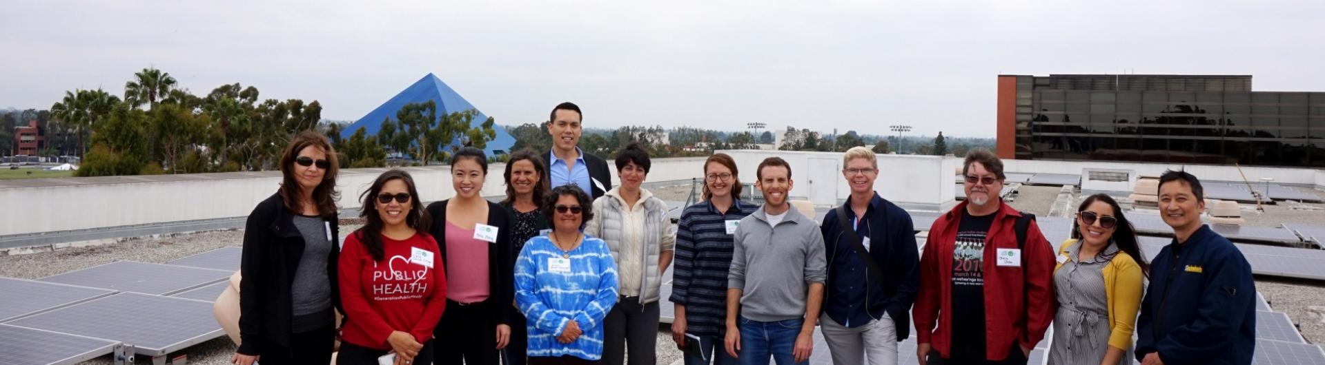 Faculty Green Thread Workshop participants touring solar panels on roof of VEC building