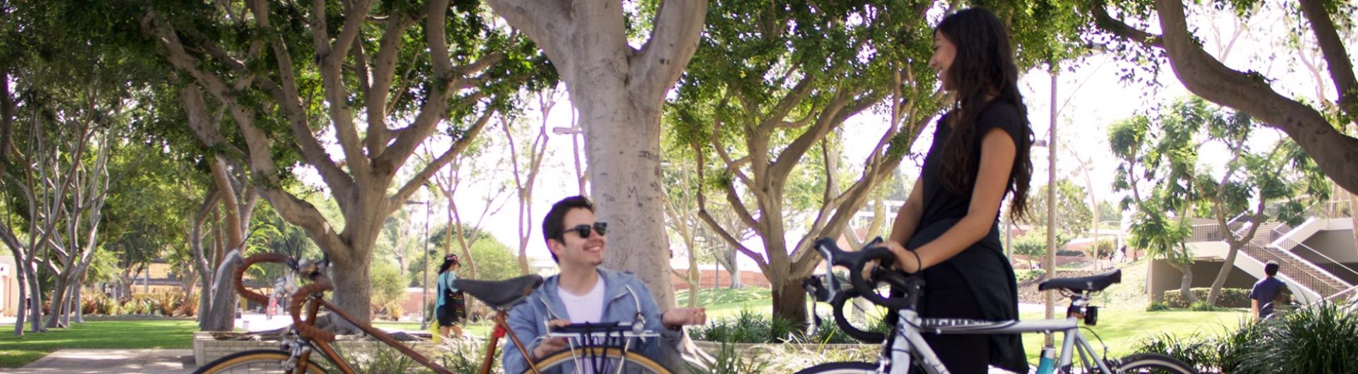 Two students with bicycles. 