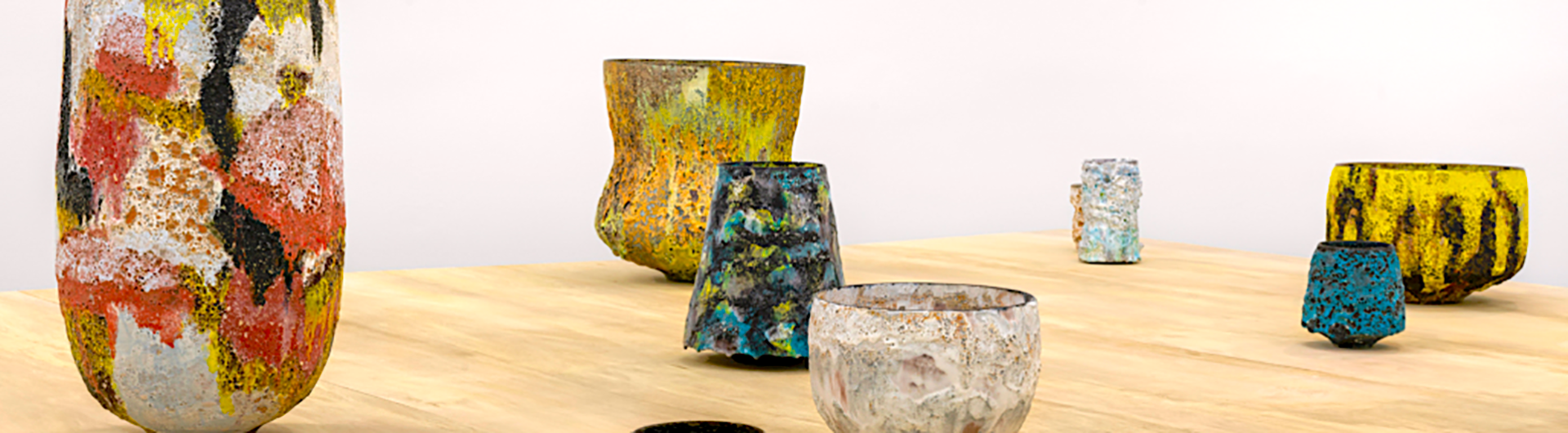 Multicolored ceramic pottery arranged on a table