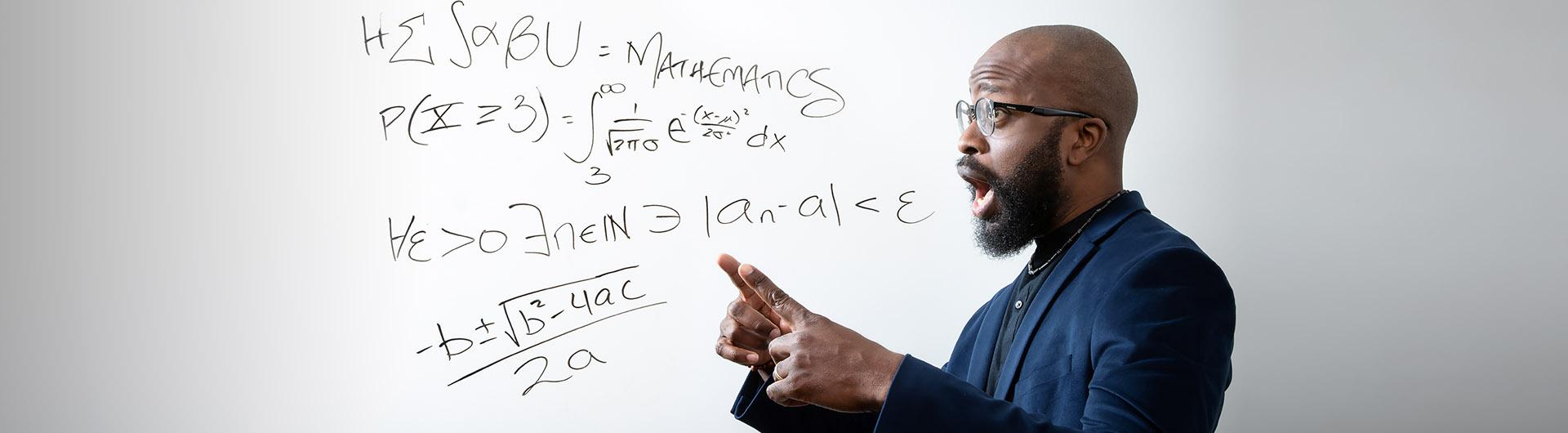 Professor Kagba Suaray points to math terms