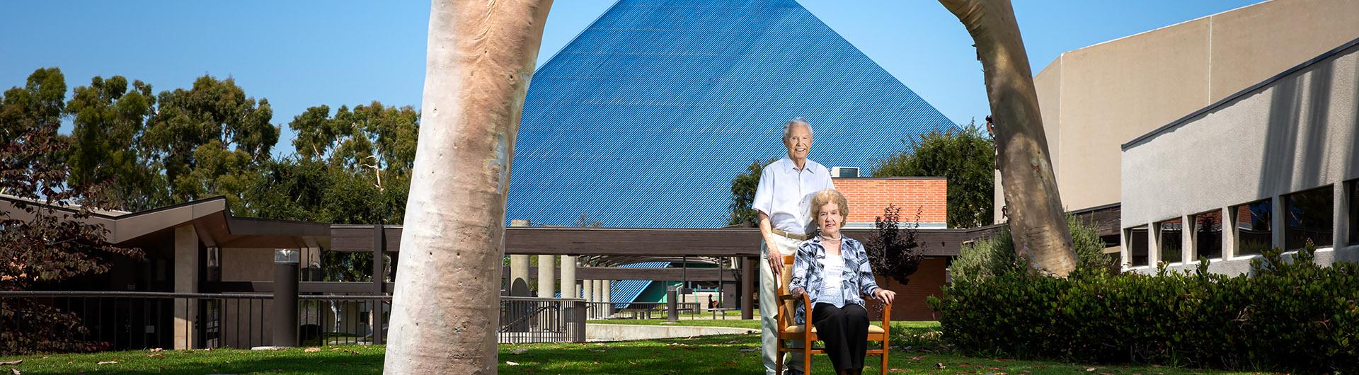 Mike and Arline Walter standing in front of the Walter Pyramid at Cal State Long Beach.
