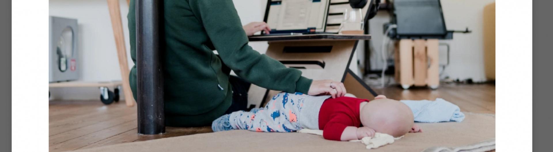 Mother working from home with a baby on the floor