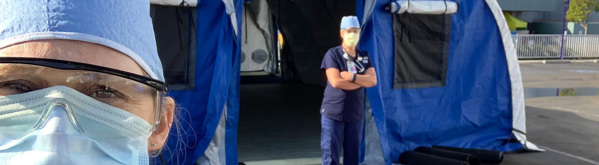 Nurses in front of a tent