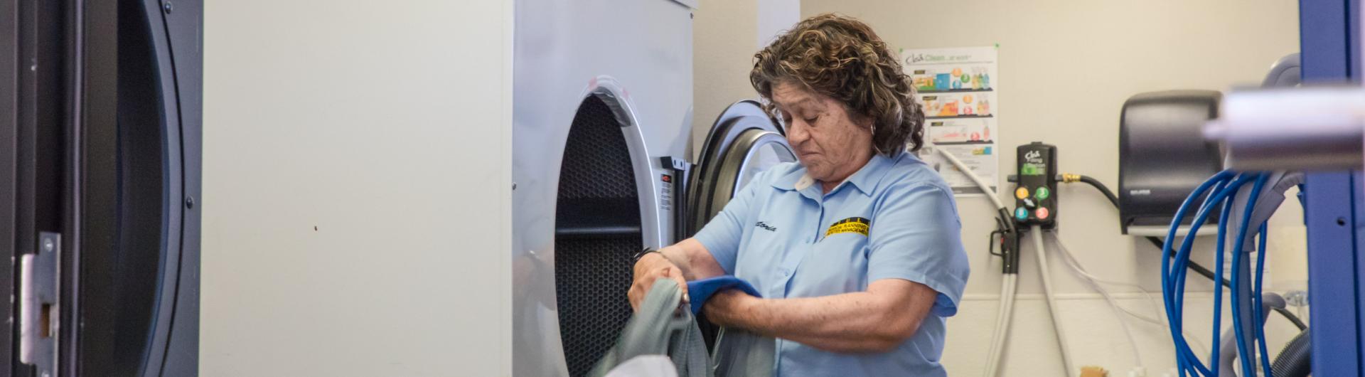 PPFM Custodial Employee Empties Washing Machine