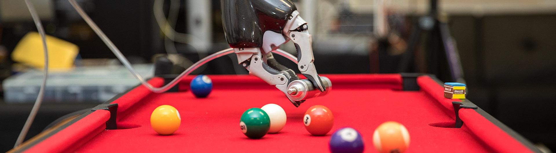 Robotic arm playing pool