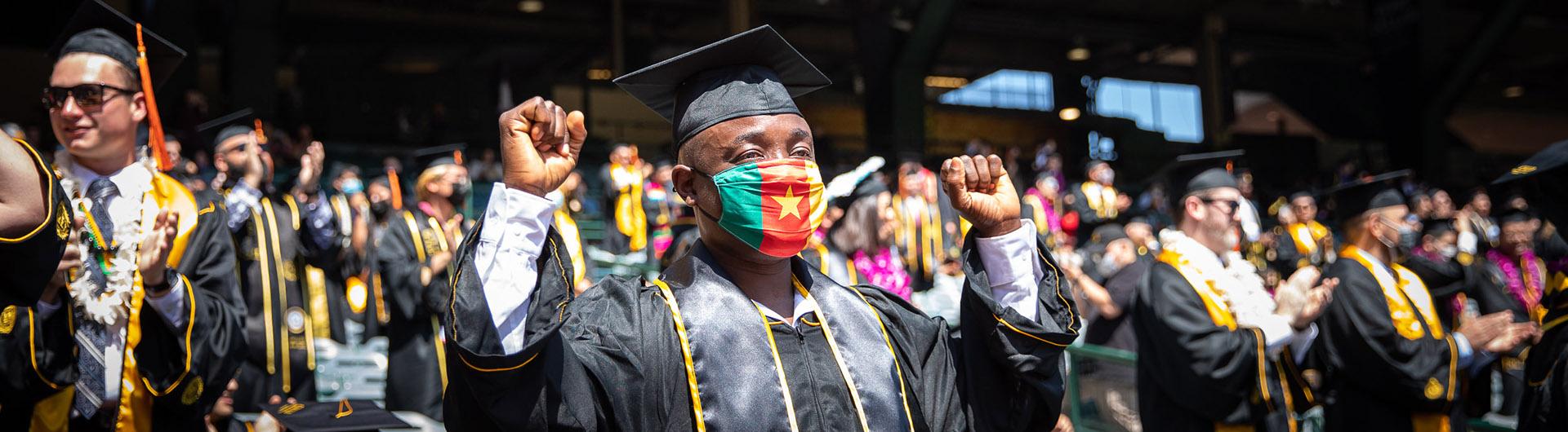 Graduate standing in crowd at commencement