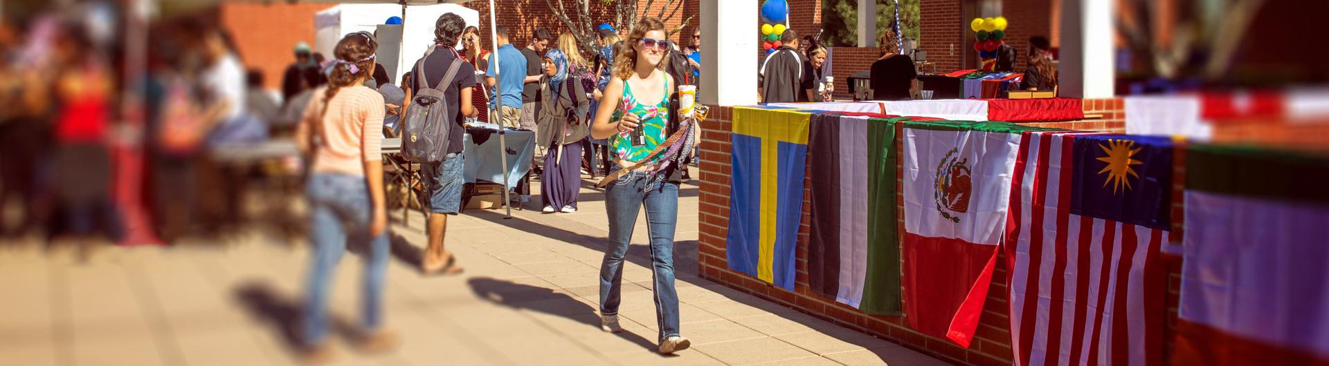 A student walks through campus during an international faire