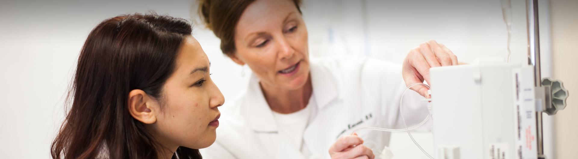 A student works with an instructor in the College of Health and Human Services