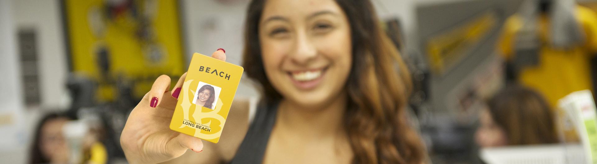 Student Holding a CSULB ID Card