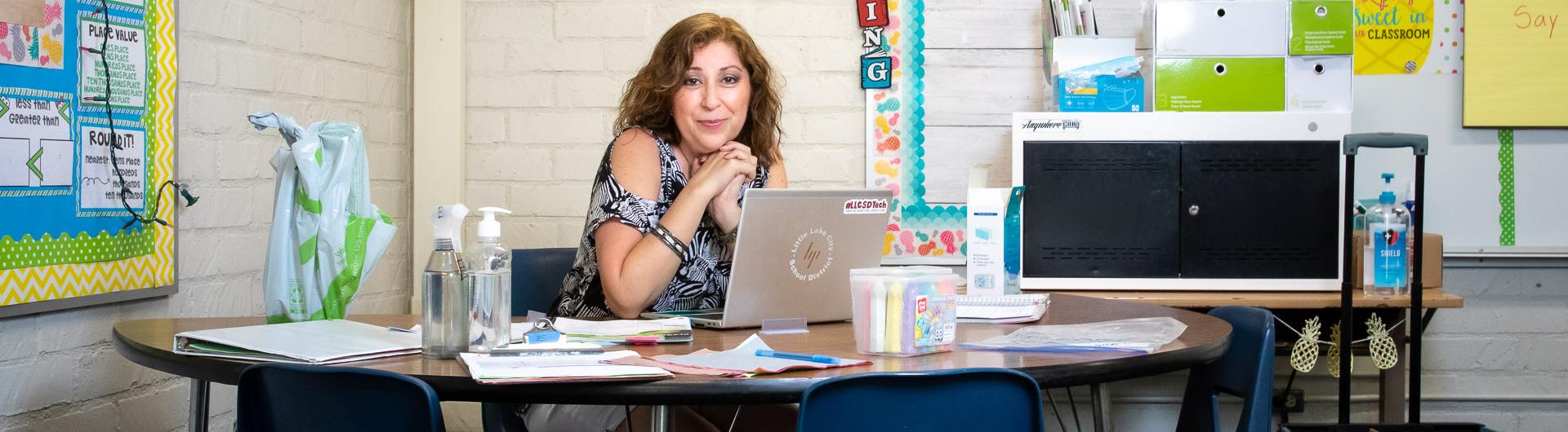 Teacher Cindy Reyes sitting at her desk