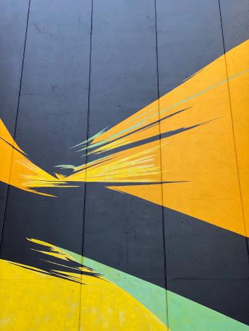 campus mural of yellow and green swathes on black