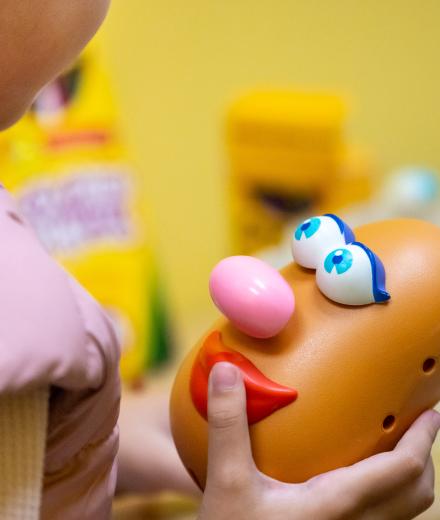 Child playing with Mr. Potato Head