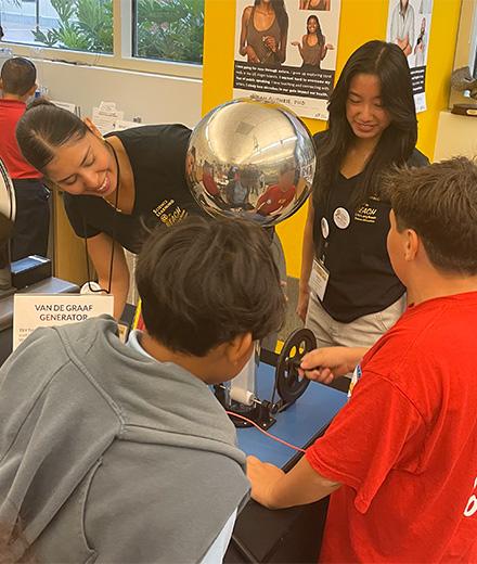 young children interacting with science exhibit