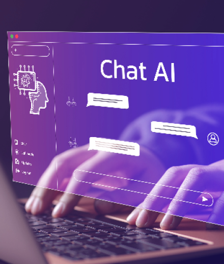 person typing on computer and using an AI chat tool
