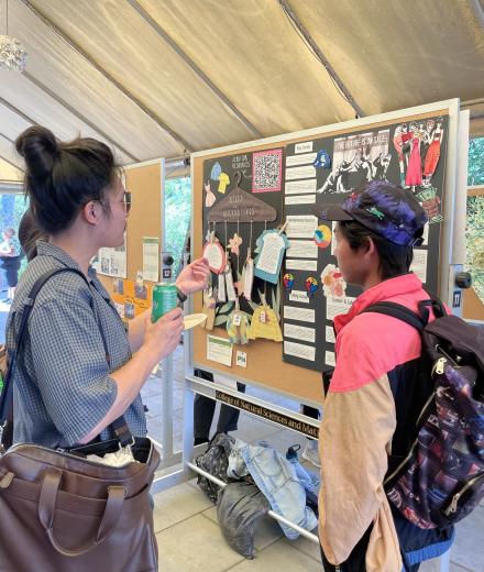 students looking at poster projects