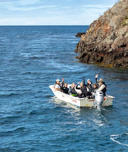 people in a boat waving goodbye