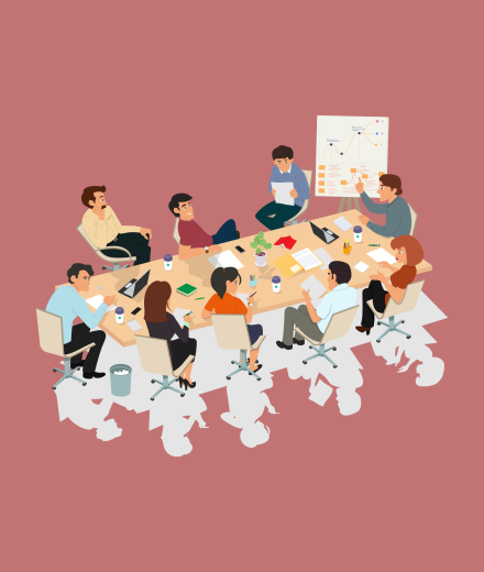 people sitting around a conference table speaking amongst themselves