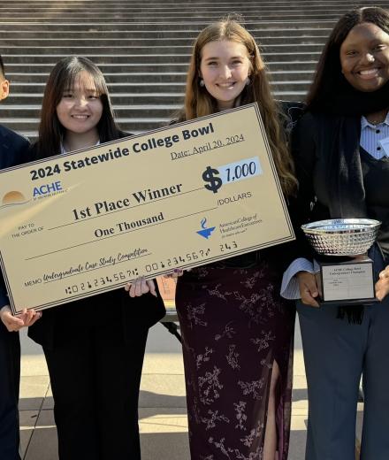 students holding award