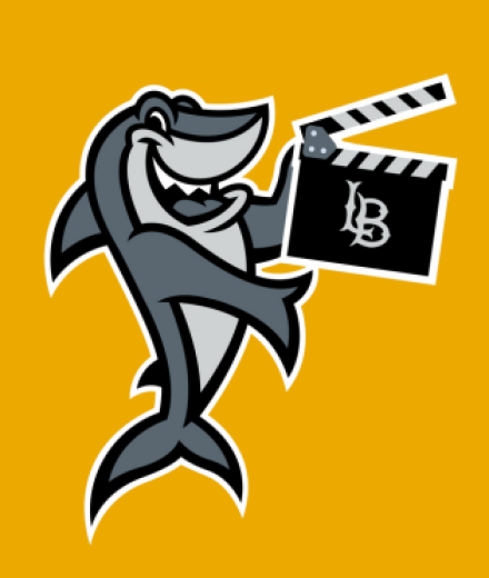 Elbee holding film clapperboard with LB on it