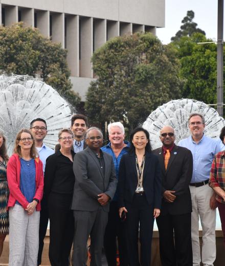 College of Engineering Deans posing for a photo in front of the Brotman Hall Foutain and the Walter Pyramid in the background