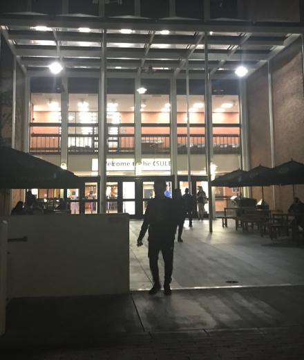 front doors of the library lit up in the dark