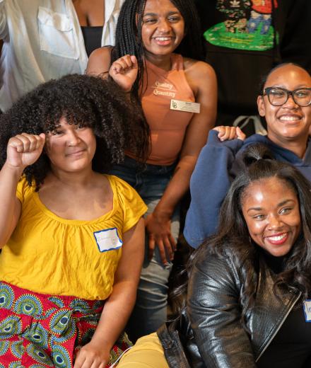 Group of Black people posing together and smiling.