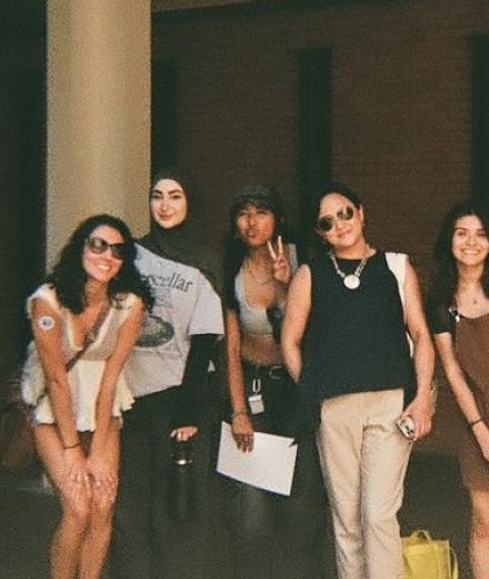 group of people posing in a dark area