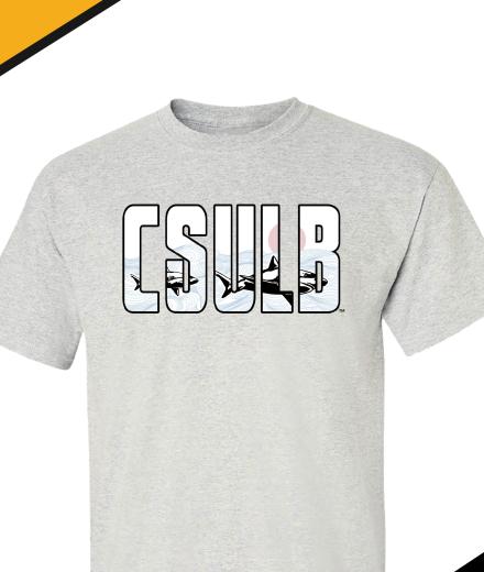 Light gray T Shirt with CSULB written on the front, where the letters are transparent so it looks like a window to under the sea where you can see two sharks swimming and a sunset over the water. 