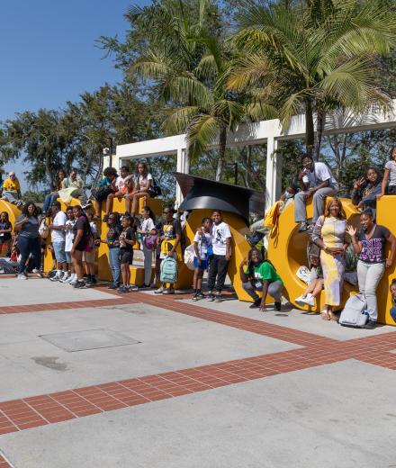 Students in front of the Go Beach sign