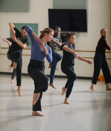 MFA student teaches a dance class in a large studio.