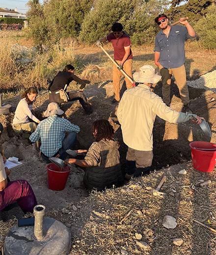 students at a dig site
