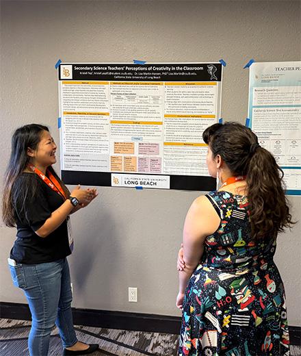 student presenting their research poster