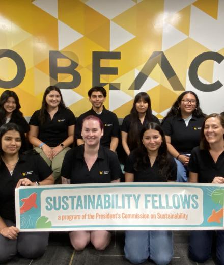 A group of students holding a banner