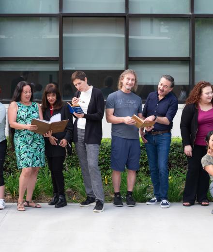 people in a line looking at books