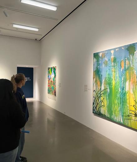 two people looking at an art piece