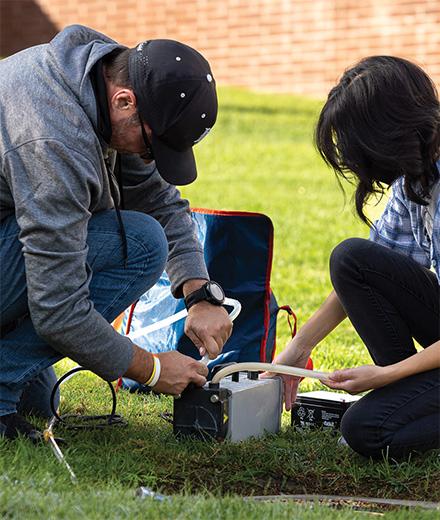 Ben Hagedorn and student researcher taking groundwater samples
