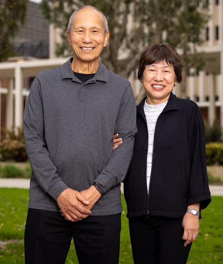 Two people stand in front of building