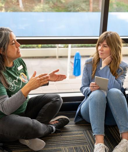 two staff members talking