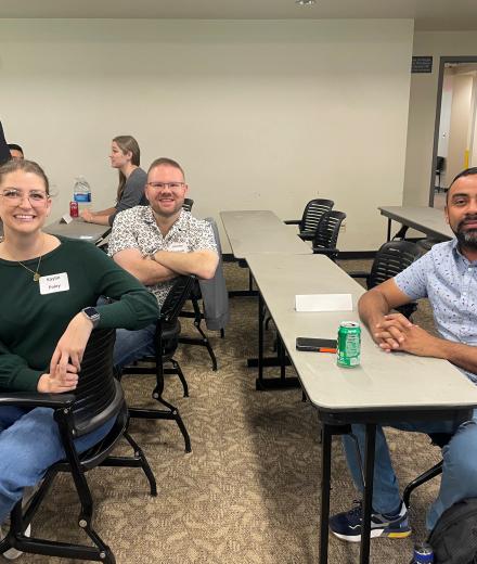 GBP Advisory Board members smiling while sitting at a desk at Spring 2026 GBP Advisory Board Retreat